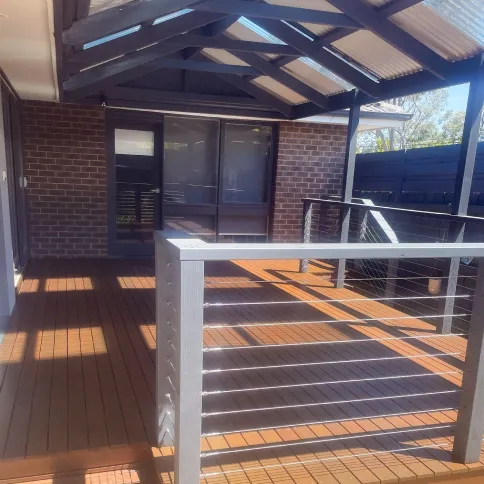 Merbau deck with a stainless wire balustrade under a gable pergola